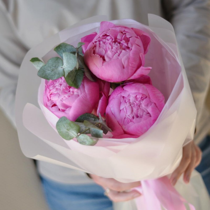 A bouquet of raspberry peonies with eucalyptus