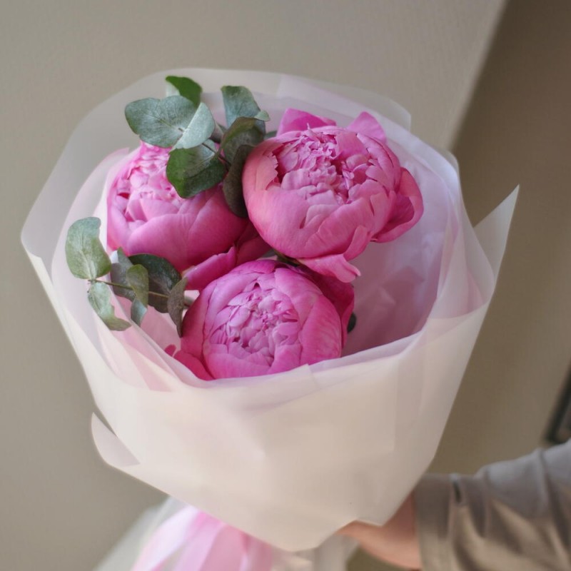 A bouquet of raspberry peonies with eucalyptus